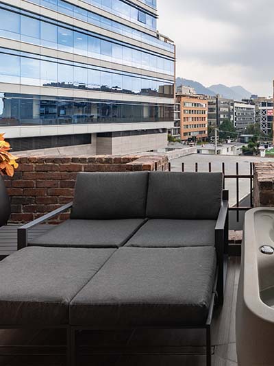 Balcony with lounge seating and hot tub